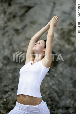 Young woman practicing yoga on the beach Young woman practicing yoga on the beach 7827404