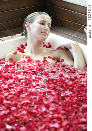 Woman having flower bath 7828615