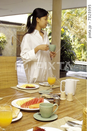 Young woman standing at the table Young woman standing at the table 7828995