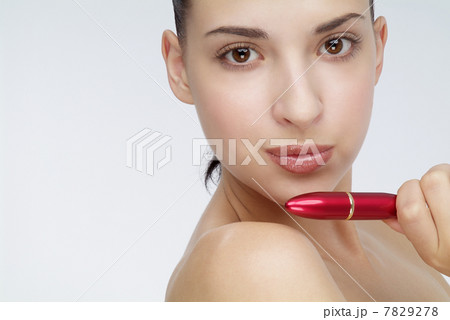 Young woman holding a lipstick 7829278