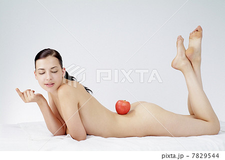 Studio shot of beautiful young woman and apple 7829544
