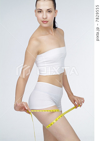 Young woman holding tape measuring 7829555
