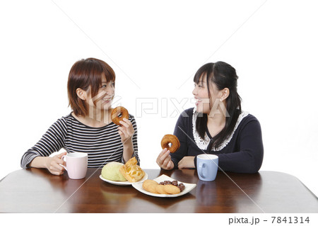おやつとおしゃべりで盛り上がる若い女性 7841314