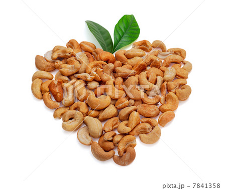 Cashew nuts in the form of heart with leaves isolated on white b Cashew nuts in the form of heart with leaves isolated on white b 7841358