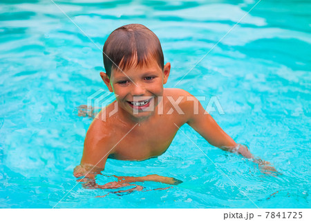 Smiling boy swims in pool on summer vacations Smiling boy swims in pool on summer vacations 7841725