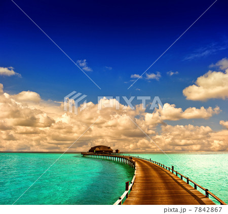 tropical sunset seascape. overwater bungalow with jetty tropical sunset seascape. overwater bungalow with jetty 7842867