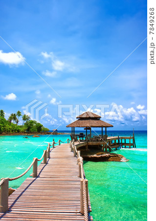 Sea with pier under blue cloudy sky Sea with pier under blue cloudy sky 7849268