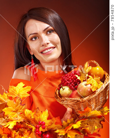 Woman holding autumn basket. 7854870