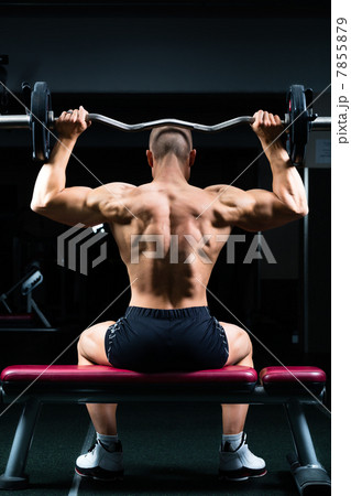 Man in gym or fitness studio on weight bench 7855879