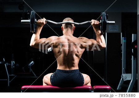 Man in gym or fitness studio on weight bench 7855880