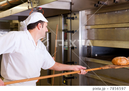 Male baker baking bread Male baker baking bread 7856597