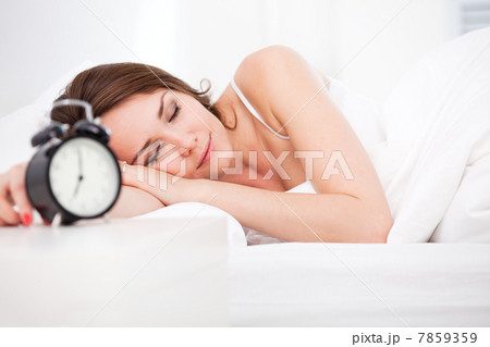 woman sleeping with alarm clock woman sleeping with alarm clock 7859359