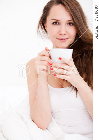 portrait of woman in bed holding a cup portrait of woman in bed holding a cup 7859697