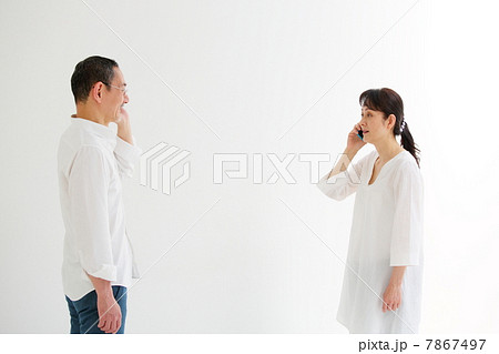 向かい合ってスマートフォンで話をするシニア男女 7867497