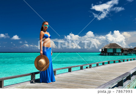 Woman on a beach jetty at Maldives 7867993
