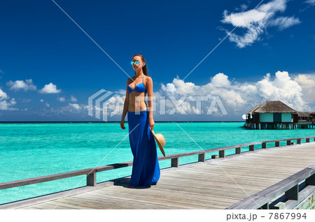 Woman on a beach jetty at Maldives 7867994