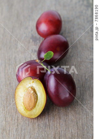 three ripe plums with leaves 7868190