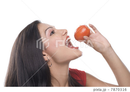 Woman about to eat a tomato  7870316