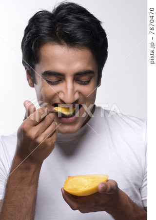 Man eating a mango Man eating a mango 7870470