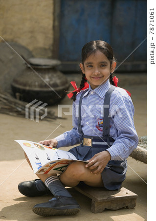 A rural school girl sitting with her boo A rural school girl sitting with her boo 7871061