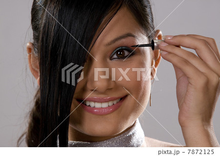 Woman applying make-up Woman applying make-up 7872125