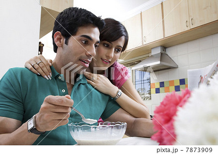 Couple looking at the morning newspaper Couple looking at the morning newspaper 7873909
