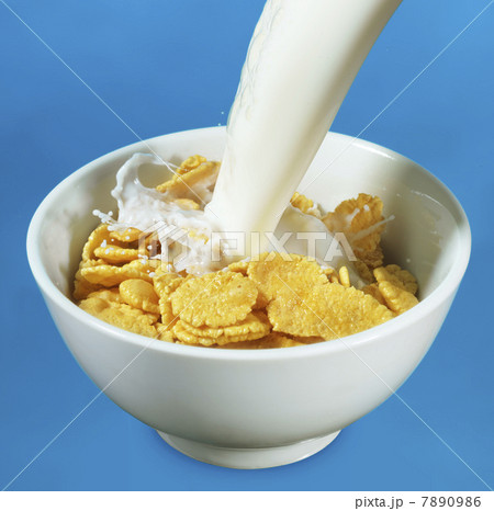 Milk pouring in a bowl of cornflakes Milk pouring in a bowl of cornflakes 7890986