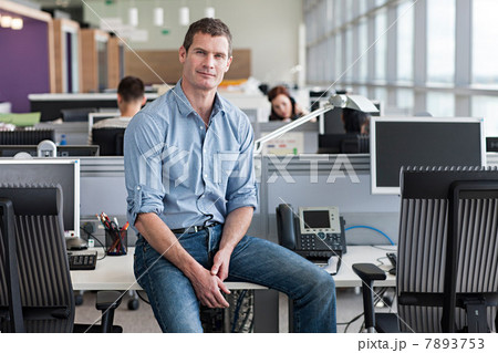Portrait of man sitting on desk 7893753