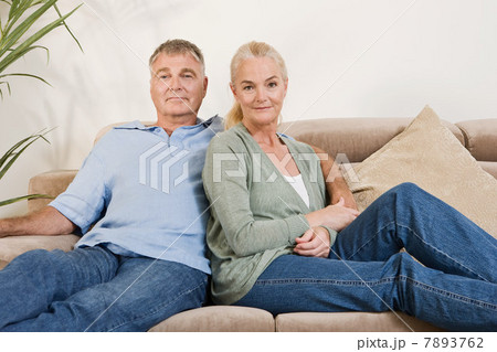 Mature couple sitting on sofa 7893762