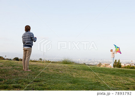 Young couple in field with kite Young couple in field with kite 7893792