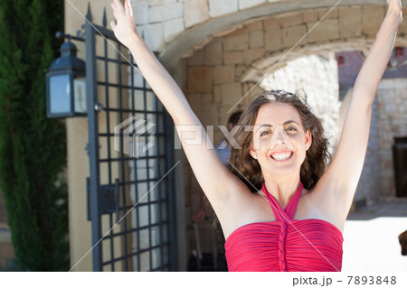Smiling woman cheering outdoors 7893848