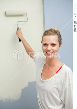 Woman painting wall 7893896