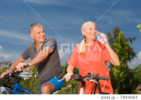 Mature couple on bicycles Mature couple on bicycles 7894664
