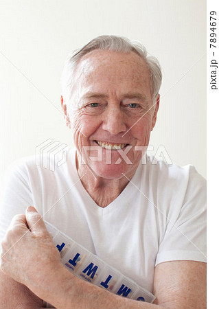 Senior man holding pill box 7894679
