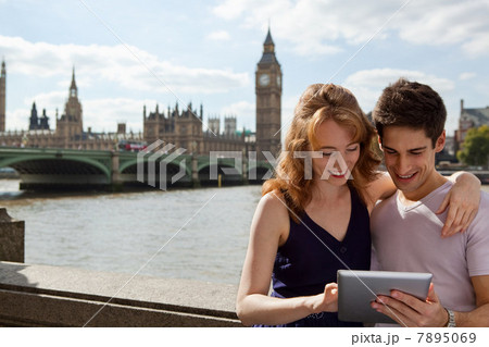 Young couple looking at a digital tablet Young couple looking at a digital tablet 7895069