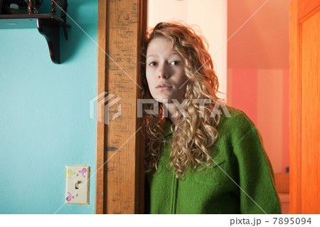 Teenage girl leaning in doorway, portrait 7895094