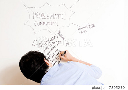 Young man writing on whiteboard Young man writing on whiteboard 7895230