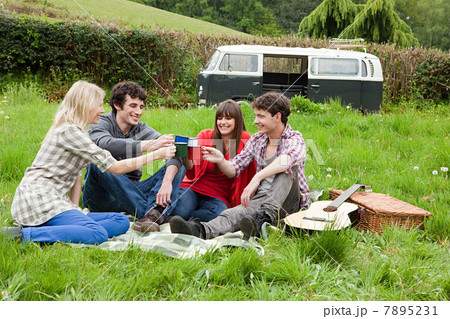 Friends toasting with mugs outdoors 7895231