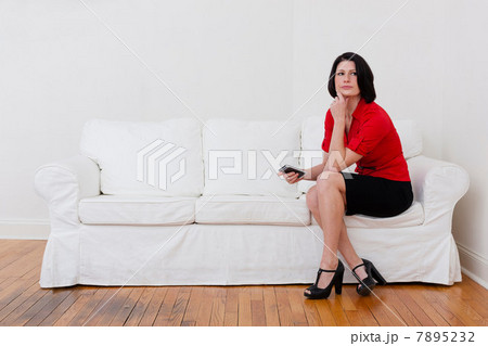 Businesswoman with cell phone on sofa Businesswoman with cell phone on sofa 7895232