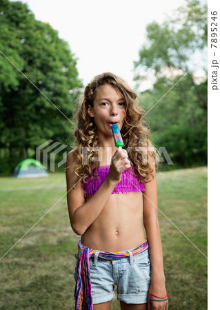 Portrait of girl eating ice lolly Portrait of girl eating ice lolly 7895246