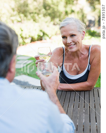 Couple toasting with wine outdoors 7895307