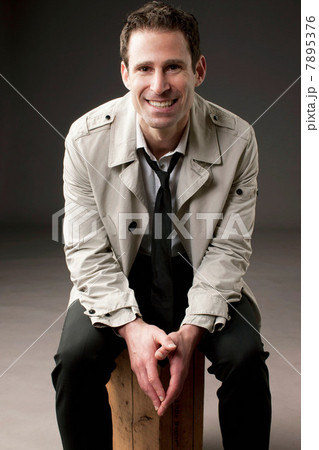 Businessman sitting on wooden box 7895376