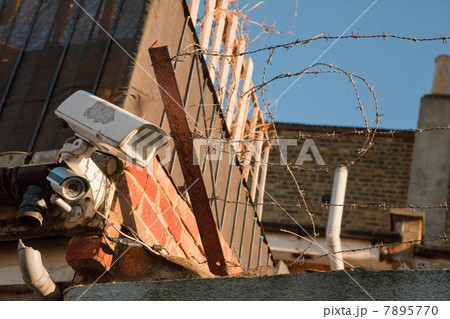 Surveillance camera and barbed wire 7895770
