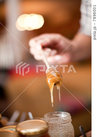 Woman examining honey in grocery Woman examining honey in grocery 7896001