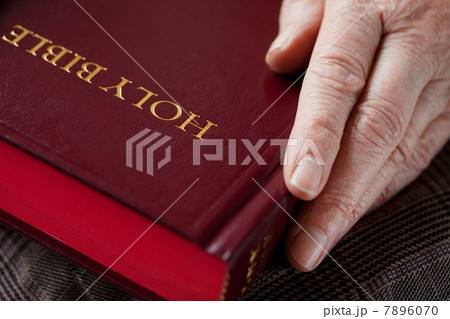 Senior woman holding bible 7896070