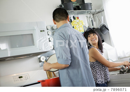 Couple cooking together in kitchen 7896071