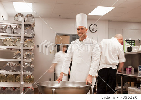 Chefs preparing food in commercial kitchen 7896220