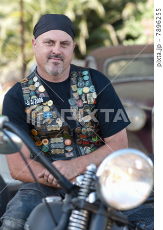 Man in leather vest on motorcycle 7896255