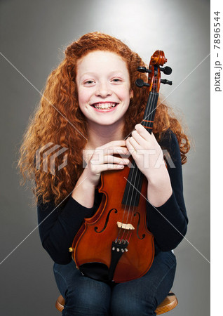 Portrait of mixed race teenage girl holding violin Portrait of mixed race teenage girl holding violin 7896544