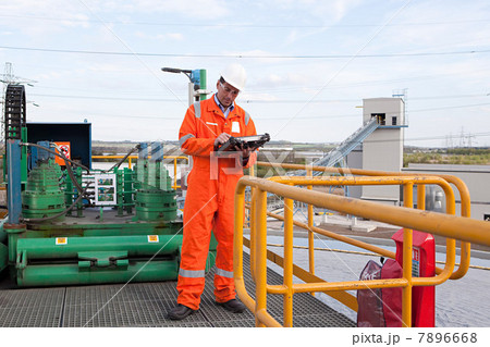 Engineer using handheld computer Engineer using handheld computer 7896668